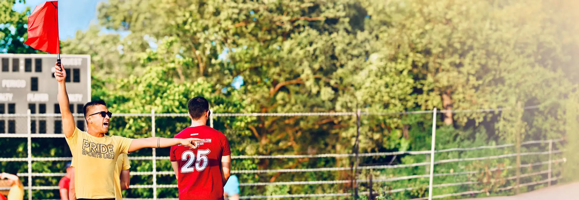 Referee raising a red flag during a Pride Sports USA game